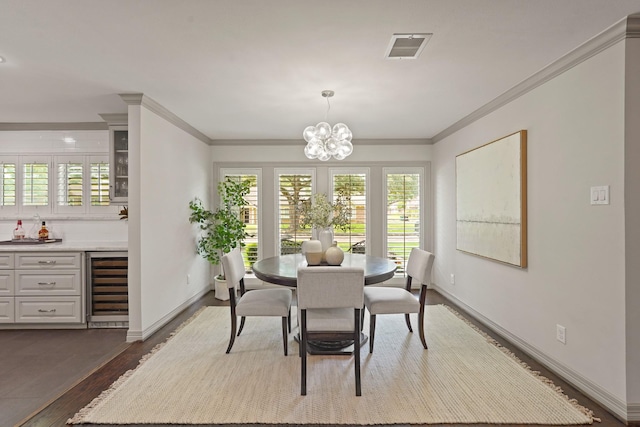 5743 Braesheather Dr, Houston, TX 77096 - dining area featuring wine cooler, healthy amount of natural light, dark wood-style flooring, a chandelier, and ornamental molding