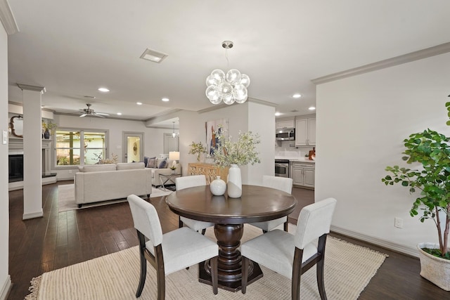 5743 Braesheather Dr, Houston, TX 77096 - dining area with a ceiling fan, dark wood-style floors, recessed lighting, a chandelier, and a fireplace with raised hearth