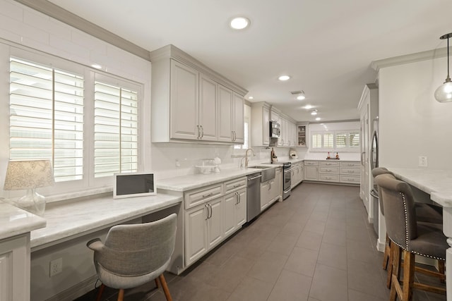 5743 Braesheather Dr, Houston, TX 77096 - kitchen featuring stainless steel appliances, tasteful backsplash, recessed lighting, tile patterned floors, and pendant lighting