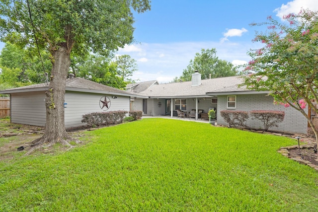 5743 Braesheather Dr, Houston, TX 77096 - rear view of property featuring a patio area, a chimney, and brick siding
