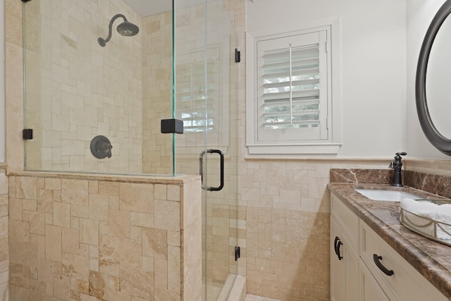 5743 Braesheather Dr, Houston, TX 77096 - bathroom featuring vanity, a shower stall, and tile walls