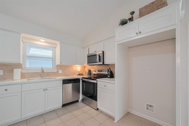 3810 Marlin Ln, La Porte, TX 77571 - kitchen with stainless steel appliances, backsplash, white cabinetry, light countertops, and light tile patterned floors