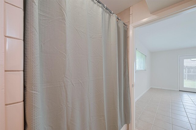 3810 Marlin Ln, La Porte, TX 77571 - bathroom view of baseboards and a shower with shower curtain