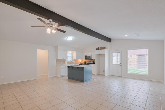 3810 Marlin Ln, La Porte, TX 77571 - kitchen with appliances with stainless steel finishes, open floor plan, white cabinets, and a kitchen island