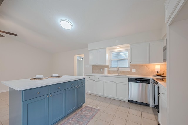 3810 Marlin Ln, La Porte, TX 77571 - kitchen with stainless steel appliances, white cabinets, decorative backsplash, light tile patterned floors, and light countertops