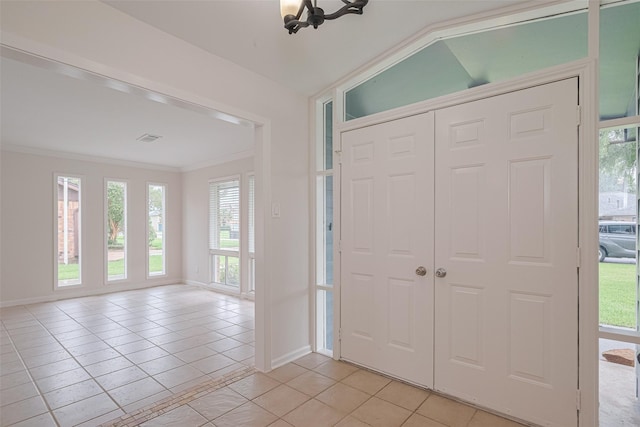 3810 Marlin Ln, La Porte, TX 77571 - foyer with light tile patterned floors, ornamental molding, healthy amount of natural light, and vaulted ceiling