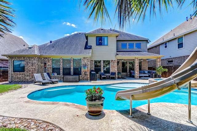 20910 Cordell Landing Dr, Richmond, TX 77407 - view of swimming pool featuring an outdoor living space, a water slide, a fenced backyard, and a patio area