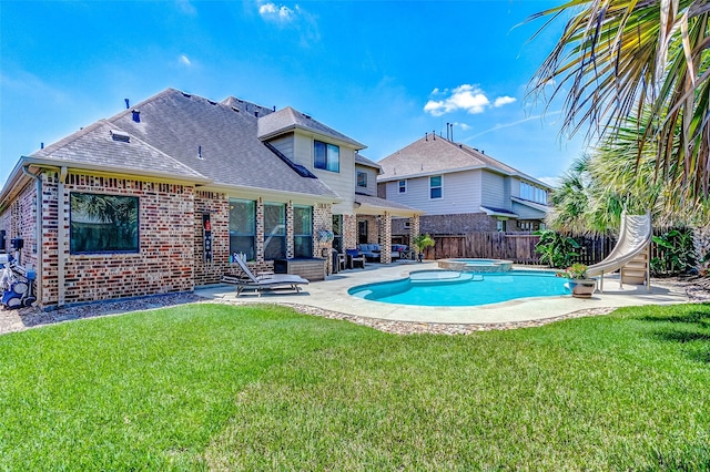 20910 Cordell Landing Dr, Richmond, TX 77407 - view of pool with a patio, a water slide, a fenced backyard, and a pool with connected hot tub