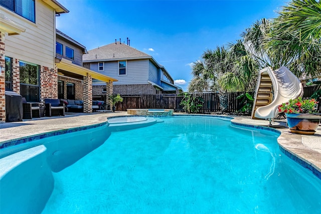 20910 Cordell Landing Dr, Richmond, TX 77407 - view of pool featuring an outdoor hangout area, a pool with connected hot tub, a fenced backyard, a water slide, and a patio area