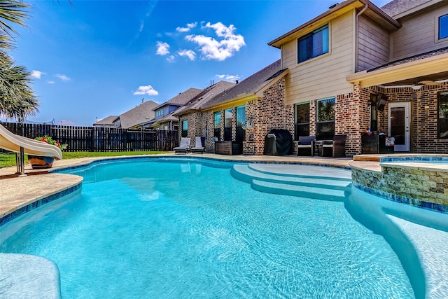 20910 Cordell Landing Dr, Richmond, TX 77407 - view of pool with a water slide, a fenced backyard, a ceiling fan, a pool with connected hot tub, and a patio area