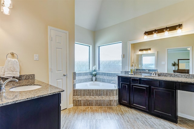 20910 Cordell Landing Dr, Richmond, TX 77407 - bathroom featuring two vanities, a bath, and high vaulted ceiling