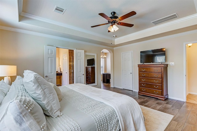 20910 Cordell Landing Dr, Richmond, TX 77407 - bedroom with a raised ceiling, crown molding, wood finished floors, arched walkways, and a ceiling fan