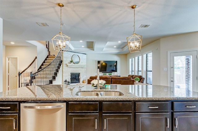 20910 Cordell Landing Dr, Richmond, TX 77407 - kitchen featuring stainless steel dishwasher, a chandelier, dark brown cabinets, pendant lighting, and recessed lighting