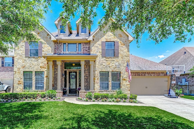 20910 Cordell Landing Dr, Richmond, TX 77407 - view of front of home with concrete driveway, an attached garage, stone siding, a front yard, and roof with shingles
