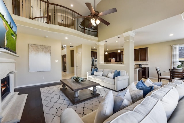 5409 Aroma Knoll Ln, Rosharon, TX 77583 - living area featuring ceiling fan, hardwood / wood-style flooring, a tile fireplace, recessed lighting, and decorative columns