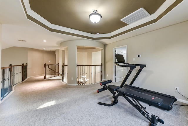 5409 Aroma Knoll Ln, Rosharon, TX 77583 - exercise area featuring a tray ceiling, carpet floors, crown molding, and arched walkways