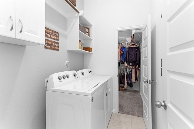 222 Speckled Woods Pl, Conroe, TX 77318 - laundry area with washing machine and dryer, cabinet space, light tile patterned floors, and light colored carpet