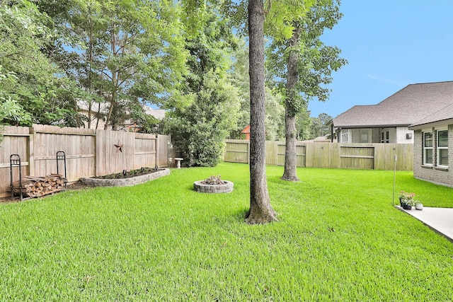 222 Speckled Woods Pl, Conroe, TX 77318 - fenced backyard with a fire pit