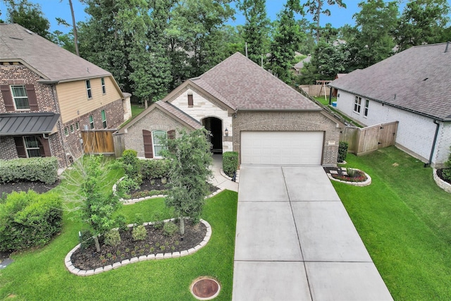 222 Speckled Woods Pl, Conroe, TX 77318 - view of front of home featuring brick siding, an attached garage, concrete driveway, and a shingled roof