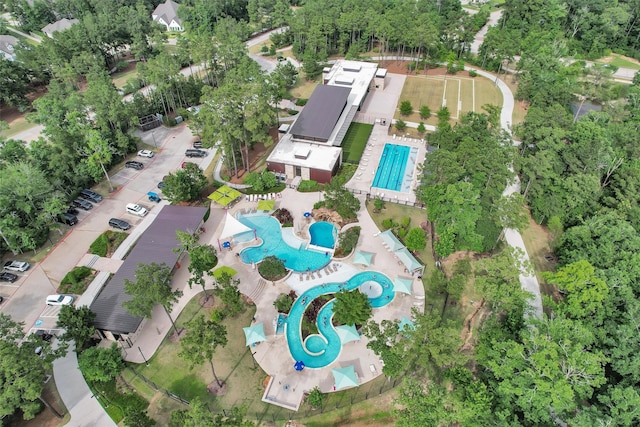 222 Speckled Woods Pl, Conroe, TX 77318 - aerial view of property and surrounding area featuring a pool area and a tree filled landscape