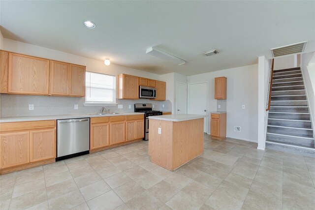 2614 Skyview Shadows Ct, Houston, TX 77047 - kitchen with appliances with stainless steel finishes, light countertops, light brown cabinetry, a center island, and recessed lighting