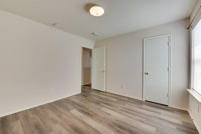 2614 Skyview Shadows Ct, Houston, TX 77047 - unfurnished bedroom with light wood-style floors and baseboards