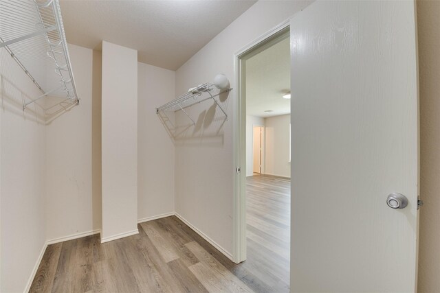 2614 Skyview Shadows Ct, Houston, TX 77047 - walk in closet featuring wood finished floors