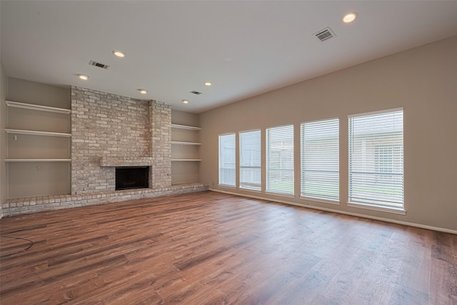 10815 Shawnbrook Dr, Houston, TX 77071 - unfurnished living room featuring built in features, wood finished floors, a fireplace, and recessed lighting