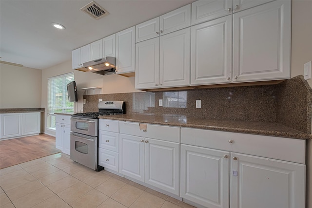 10815 Shawnbrook Dr, Houston, TX 77071 - kitchen featuring double oven range, white cabinetry, tasteful backsplash, under cabinet range hood, and recessed lighting