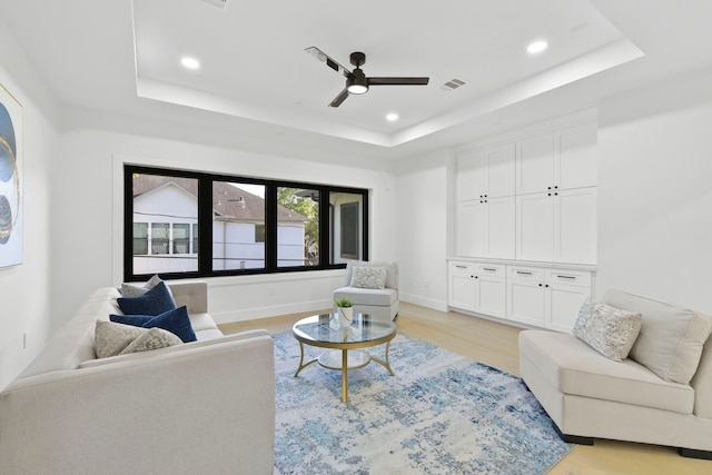 5115 Maple St, Houston, TX 77401 - living area with a tray ceiling, a ceiling fan, light wood-type flooring, and recessed lighting