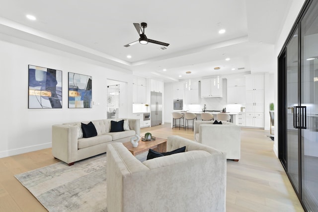 5115 Maple St, Houston, TX 77401 - living room with a raised ceiling, a ceiling fan, recessed lighting, and light wood-style floors