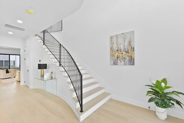 5115 Maple St, Houston, TX 77401 - staircase with wood finished floors and recessed lighting