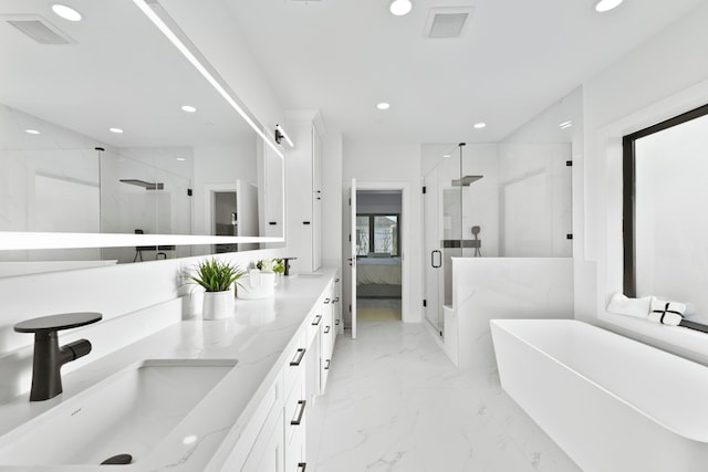 5115 Maple St, Houston, TX 77401 - ensuite bathroom featuring a marble finish shower, recessed lighting, double vanity, a soaking tub, and marble finish floors