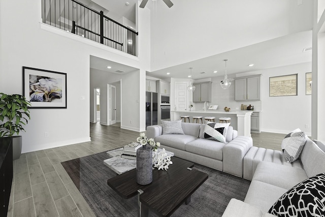 3244 Stingray Cove Dr, Katy, TX 77493 - living room featuring light wood finished floors, ceiling fan, recessed lighting, and a towering ceiling