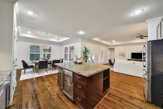 1822 Gardenia Dr, Houston, TX 77018 - kitchen featuring freestanding refrigerator, a raised ceiling, dark wood finished floors, crown molding, and open floor plan