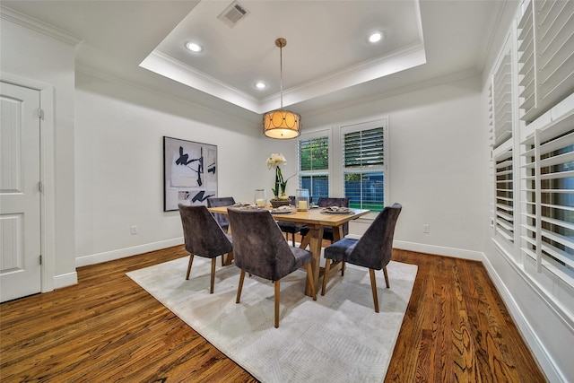 1822 Gardenia Dr, Houston, TX 77018 - dining room featuring crown molding, dark wood-type flooring, a raised ceiling, and recessed lighting