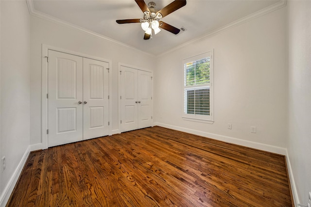 1822 Gardenia Dr, Houston, TX 77018 - unfurnished bedroom with multiple closets, crown molding, dark wood-type flooring, and a ceiling fan