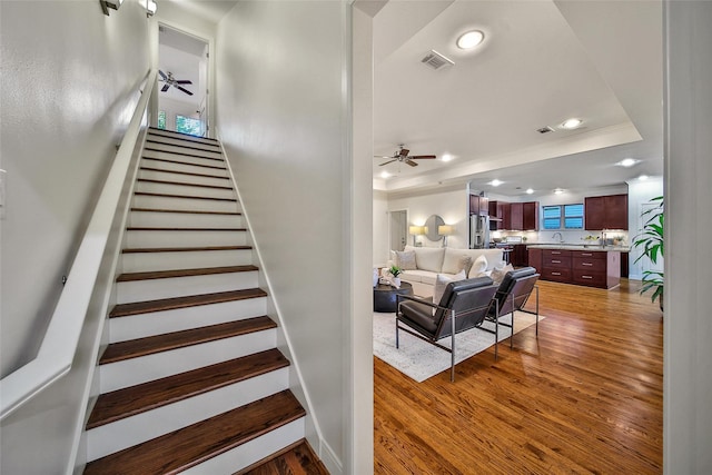 1822 Gardenia Dr, Houston, TX 77018 - stairway featuring a tray ceiling, ceiling fan, wood finished floors, recessed lighting, and ornamental molding