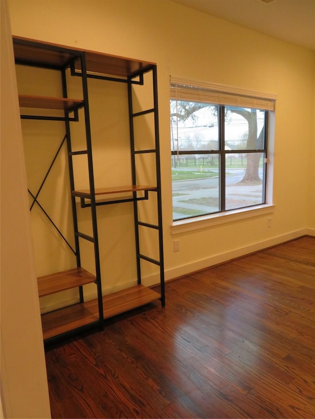 4730 Bell St, Houston, TX 77023 - unfurnished bedroom with dark wood-style floors and baseboards