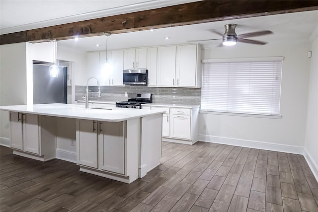 12110 Timberlake Dr, Cypress, TX 77429 - kitchen featuring stainless steel appliances, dark wood finished floors, beam ceiling, light countertops, and white cabinetry