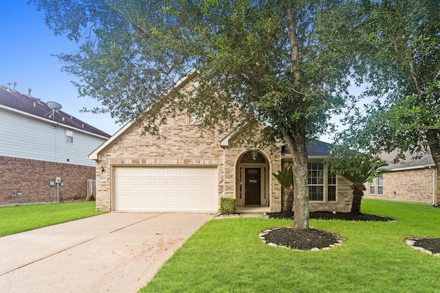 1627 Pebble Brk, Missouri City, TX 77459 - traditional-style house with driveway, a front lawn, an attached garage, and brick siding