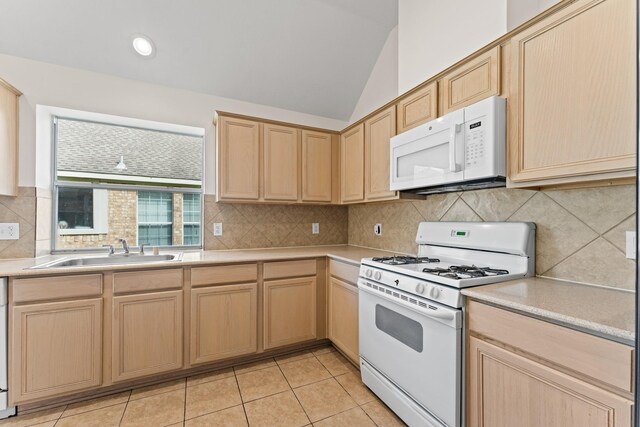 1627 Pebble Brk, Missouri City, TX 77459 - kitchen featuring white appliances, light brown cabinets, light countertops, vaulted ceiling, and light tile patterned flooring