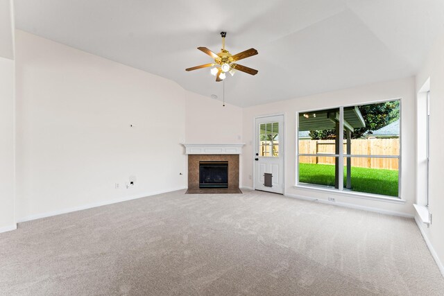 1627 Pebble Brk, Missouri City, TX 77459 - unfurnished living room with ceiling fan, a tiled fireplace, carpet flooring, and lofted ceiling