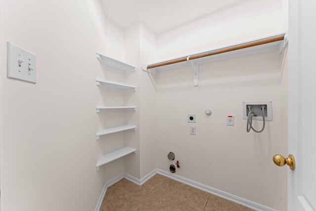 1627 Pebble Brk, Missouri City, TX 77459 - laundry area featuring gas dryer hookup, hookup for a washing machine, light tile patterned floors, and electric dryer hookup
