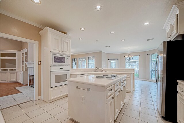 3110 Meadow Oak Dr, Houston, TX 77068 - kitchen with white appliances, light tile patterned floors, ornamental molding, light countertops, and a kitchen island