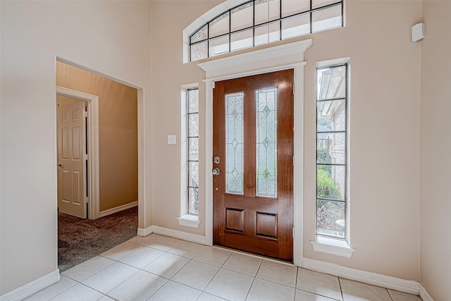 3110 Meadow Oak Dr, Houston, TX 77068 - foyer entrance with light tile patterned floors, a towering ceiling, and light carpet