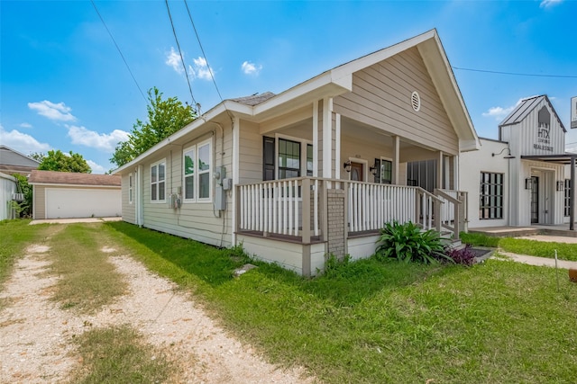4519 N Main St, Houston, TX 77009 - view of front of house with a porch, a detached garage, and a front lawn