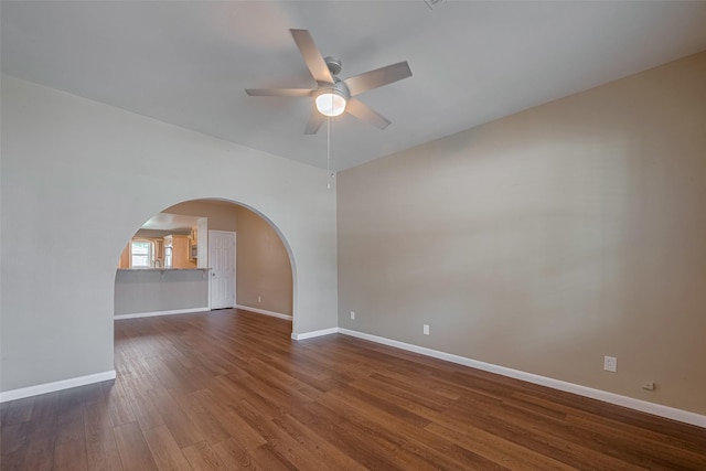 4519 N Main St, Houston, TX 77009 - unfurnished room featuring a ceiling fan, dark wood-style floors, and arched walkways