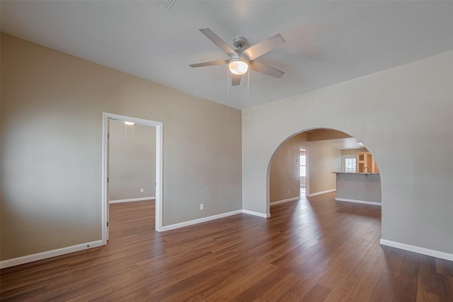 4519 N Main St, Houston, TX 77009 - empty room featuring arched walkways, ceiling fan, and hardwood / wood-style floors