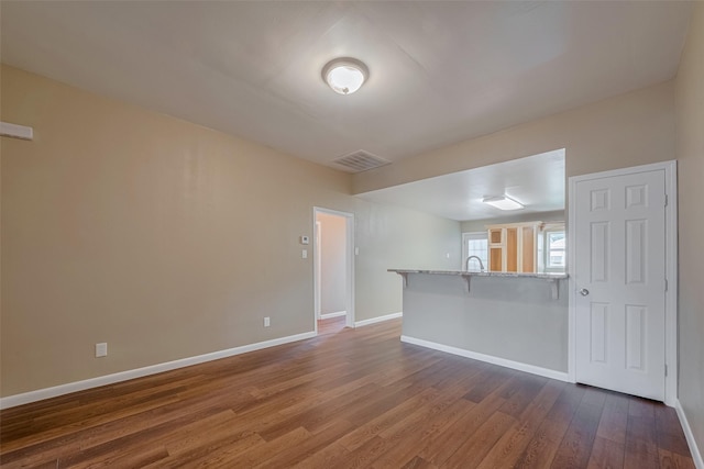 4519 N Main St, Houston, TX 77009 - unfurnished room featuring baseboards and dark wood-style floors